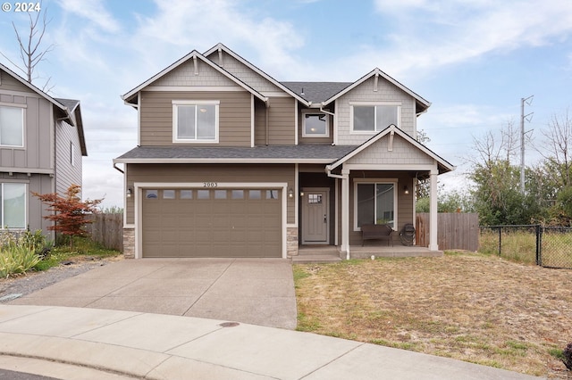 craftsman-style house with a garage and a front lawn