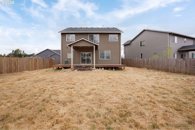 rear view of house featuring a yard