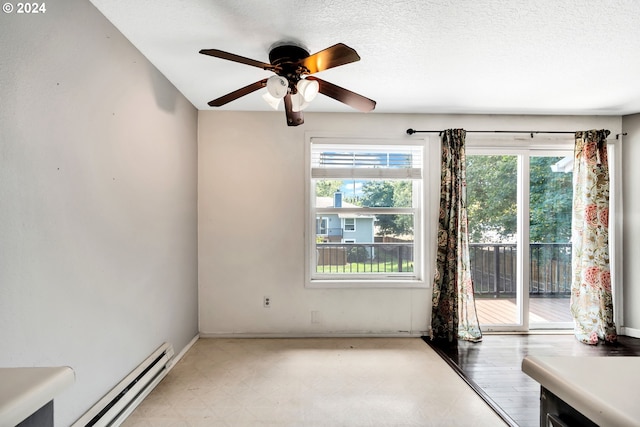 empty room featuring a baseboard radiator, a textured ceiling, and ceiling fan