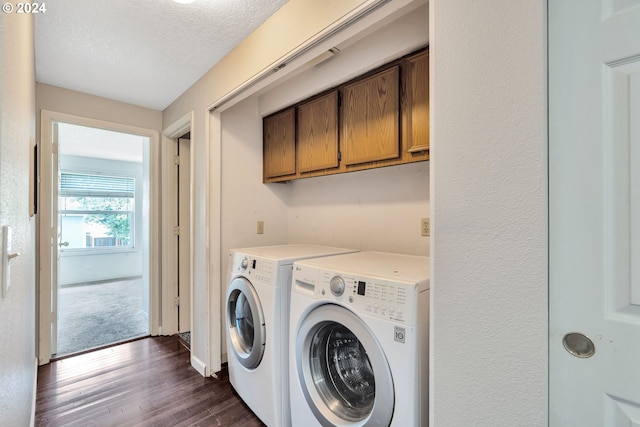 laundry area featuring cabinets, separate washer and dryer, a textured ceiling, and dark hardwood / wood-style floors