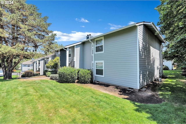 view of side of property with a yard