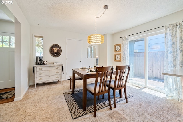3427 NE 32nd Pl, Portland, OR 97212 - dining room featuring light colored carpet, a textured ceiling, and baseboards