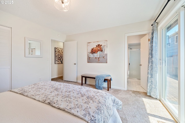 3427 NE 32nd Pl, Portland, OR 97212 - carpeted bedroom featuring multiple windows, ensuite bathroom, and baseboards