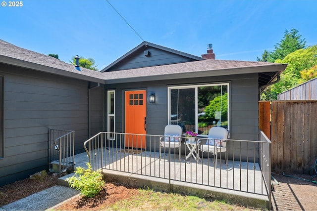 3427 NE 32nd Pl, Portland, OR 97212 - view of front of home with a patio area, roof with shingles, and a chimney