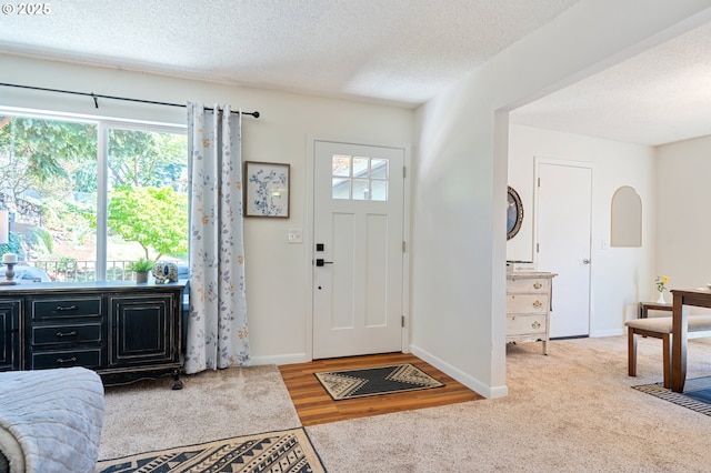 3427 NE 32nd Pl, Portland, OR 97212 - carpeted foyer featuring a textured ceiling and baseboards