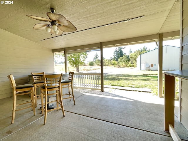 sunroom / solarium with ceiling fan and plenty of natural light