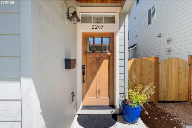 entrance to property featuring fence