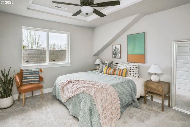 bedroom featuring baseboards, visible vents, ceiling fan, a raised ceiling, and carpet flooring