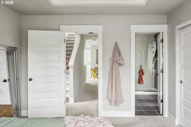 carpeted bedroom featuring tile patterned flooring and baseboards