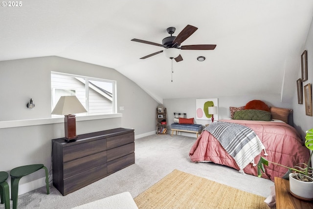 carpeted bedroom with baseboards, lofted ceiling, and a ceiling fan