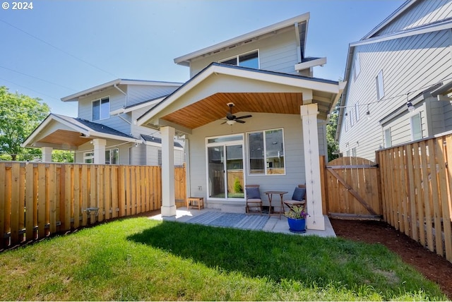 rear view of property featuring a lawn, a gate, a patio, a fenced backyard, and ceiling fan