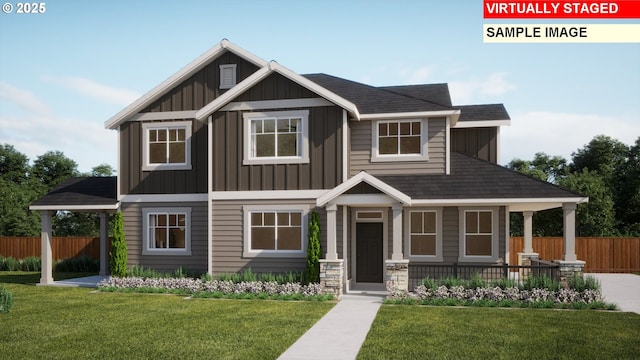 craftsman house featuring board and batten siding, a front yard, and fence