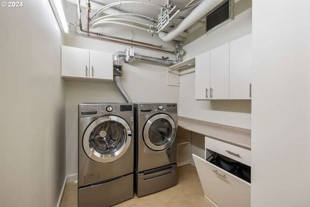 laundry room featuring cabinet space and washing machine and clothes dryer