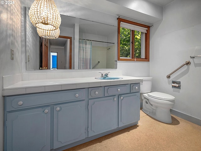 bathroom with walk in shower, a notable chandelier, vanity, and toilet