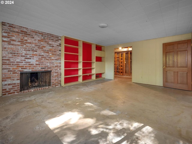 unfurnished living room featuring a fireplace and concrete flooring