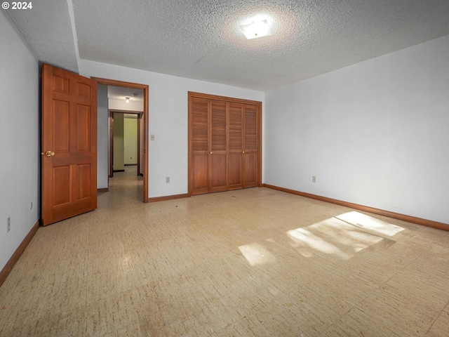 unfurnished bedroom featuring a closet and a textured ceiling