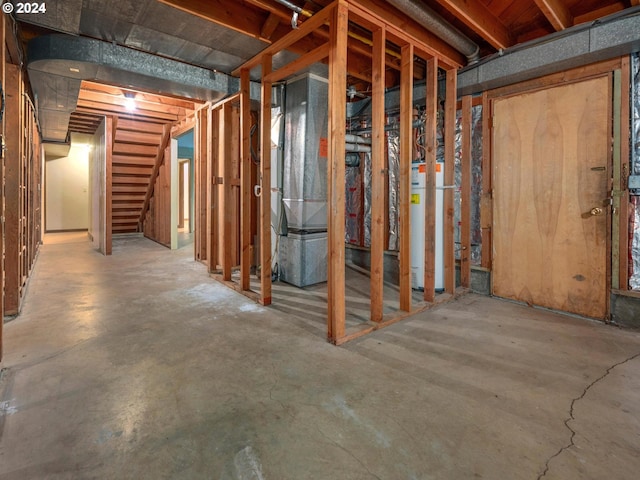 basement featuring gas water heater and heating unit