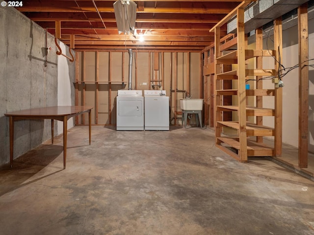 basement with washing machine and clothes dryer and sink