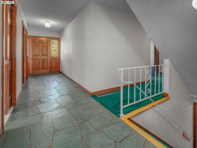 foyer entrance featuring a textured ceiling