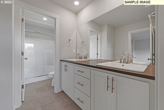 bathroom with a shower with door, toilet, and vanity