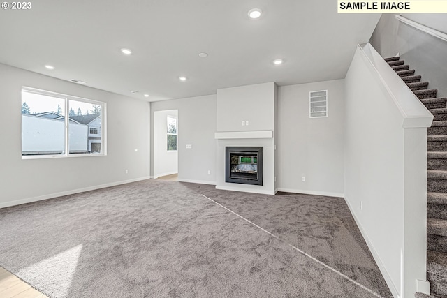 unfurnished living room with carpet floors