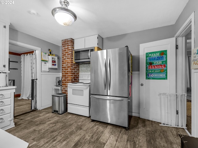616 Park Ave, Tillamook, OR 97141 - kitchen featuring dark wood-type flooring, light countertops, white cabinets, wainscoting, and appliances with stainless steel finishes