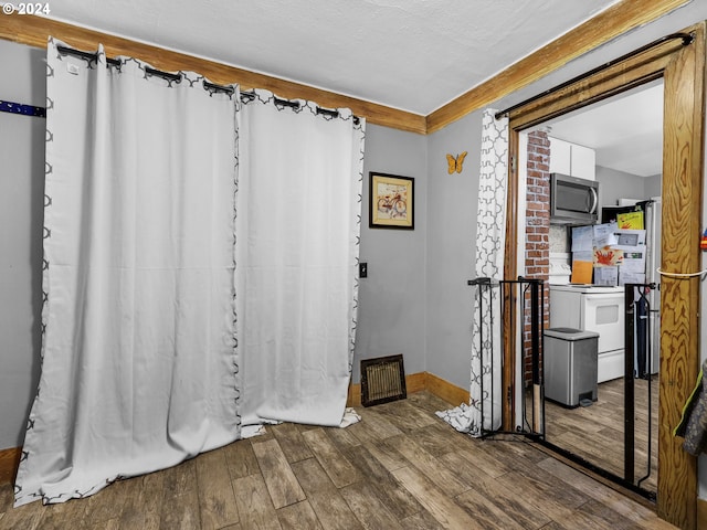 bathroom featuring wood-type flooring and a textured ceiling