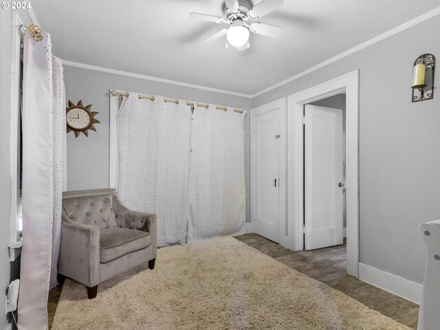 616 Park Ave, Tillamook, OR 97141 - sitting room featuring crown molding, wood finished floors, baseboards, and a ceiling fan