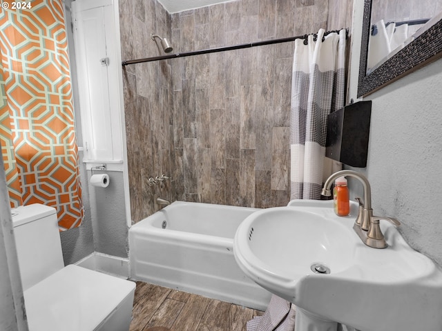 full bathroom with hardwood / wood-style floors, sink, toilet, and shower / tub combo with curtain