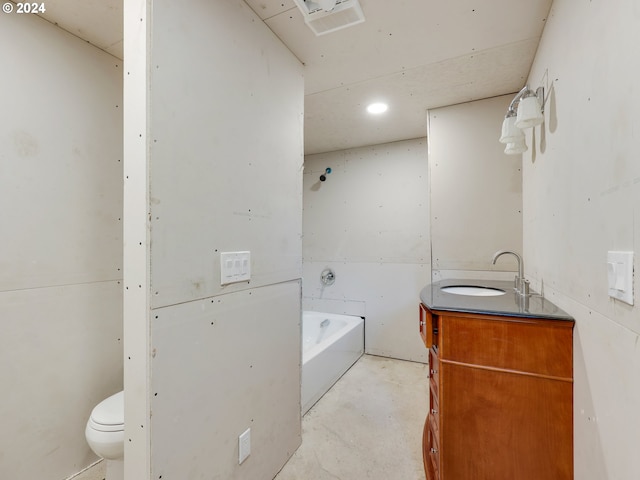 bathroom featuring concrete flooring, a washtub, vanity, and toilet