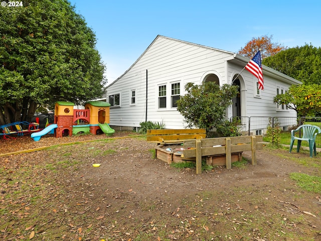 rear view of house with a playground