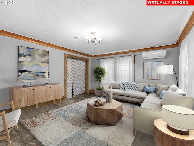 living room with dark wood-type flooring, a wall unit AC, an inviting chandelier, and crown molding