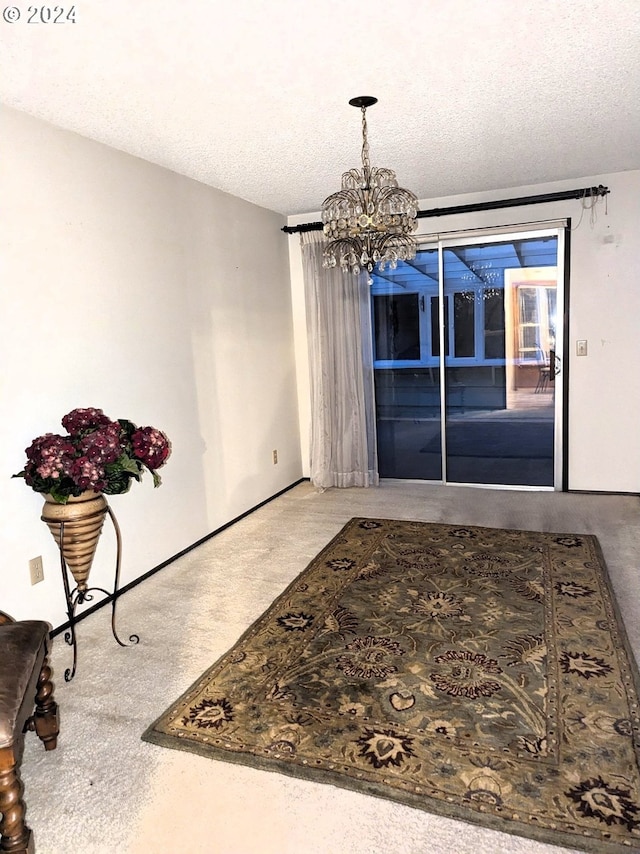 dining area featuring carpet, a textured ceiling, and an inviting chandelier