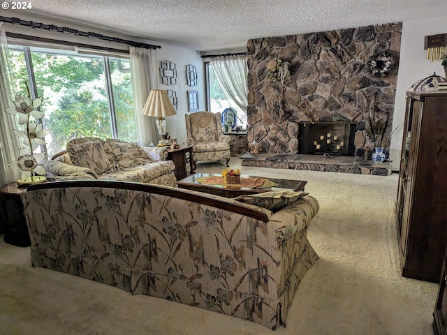 living room with carpet, a stone fireplace, and a textured ceiling