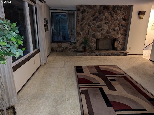 living room with carpet flooring and a fireplace