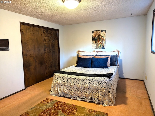 bedroom featuring a textured ceiling and carpet floors