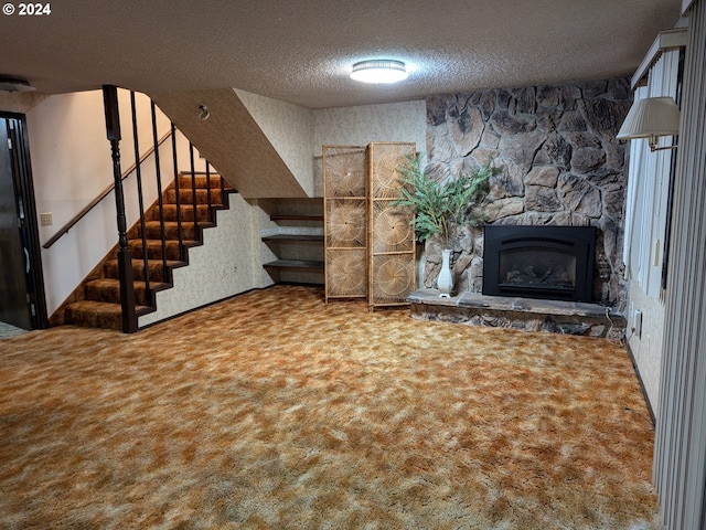 unfurnished living room featuring a fireplace, a textured ceiling, and carpet floors