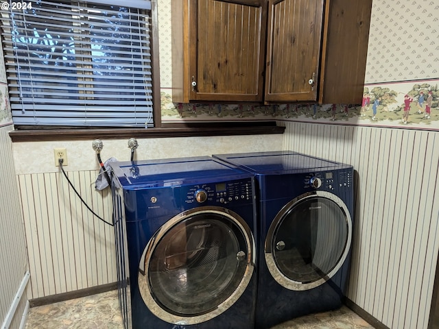 laundry area featuring cabinets and washer and clothes dryer