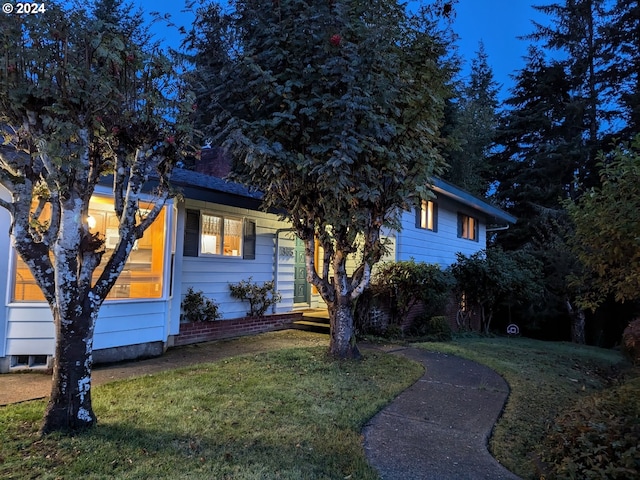 obstructed view of property with a front yard