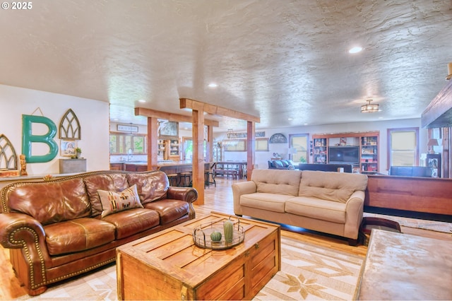 living room featuring a textured ceiling and light hardwood / wood-style floors