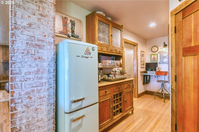 48612 Duff Rd, Adams, OR 97810 - kitchen with light wood finished floors, freestanding refrigerator, glass insert cabinets, brown cabinets, and light countertops