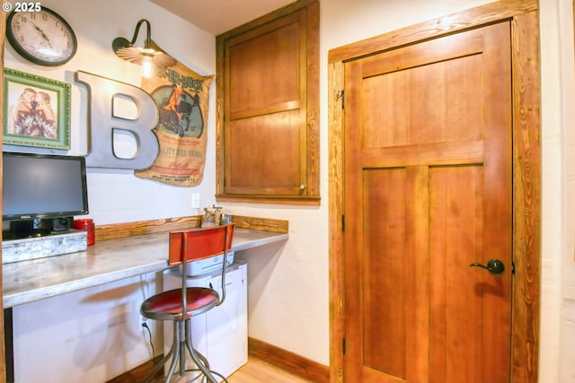 48612 Duff Rd, Adams, OR 97810 - kitchen with built in study area, brown cabinetry, light wood-type flooring, and light countertops