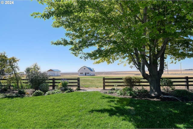 view of yard with a rural view