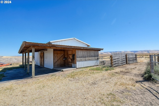 view of outbuilding with a mountain view and a rural view