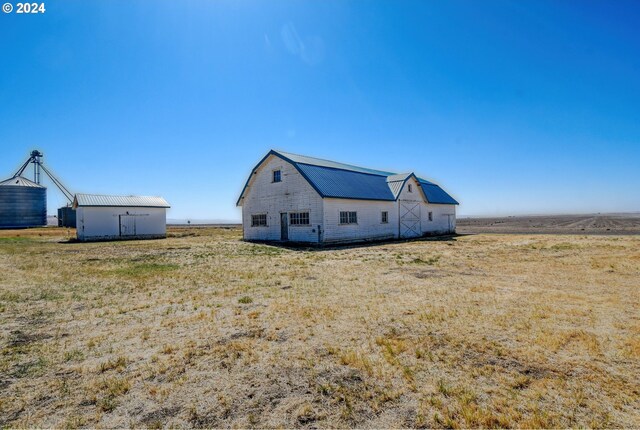 48612 Duff Rd, Adams, OR 97810 - exterior space with a gambrel roof, an outbuilding, a barn, and metal roof