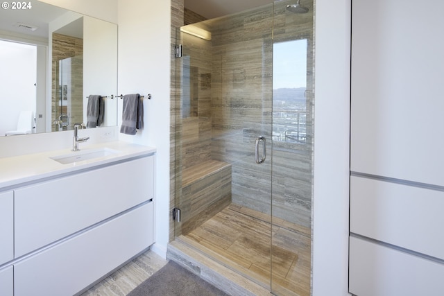 bathroom with vanity and an enclosed shower