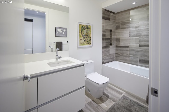 full bathroom featuring vanity, toilet, and tiled shower / bath combo