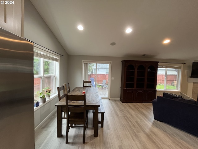 dining area featuring light hardwood / wood-style flooring and lofted ceiling