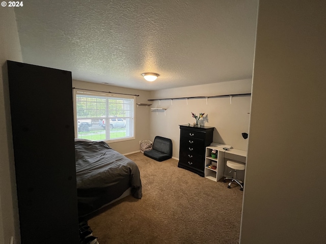 carpeted bedroom with a textured ceiling