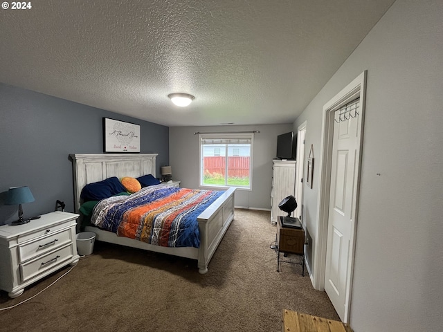 carpeted bedroom featuring a textured ceiling